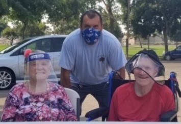 UCPCC staffer Juan Mercado visits with students Judy and Jack.