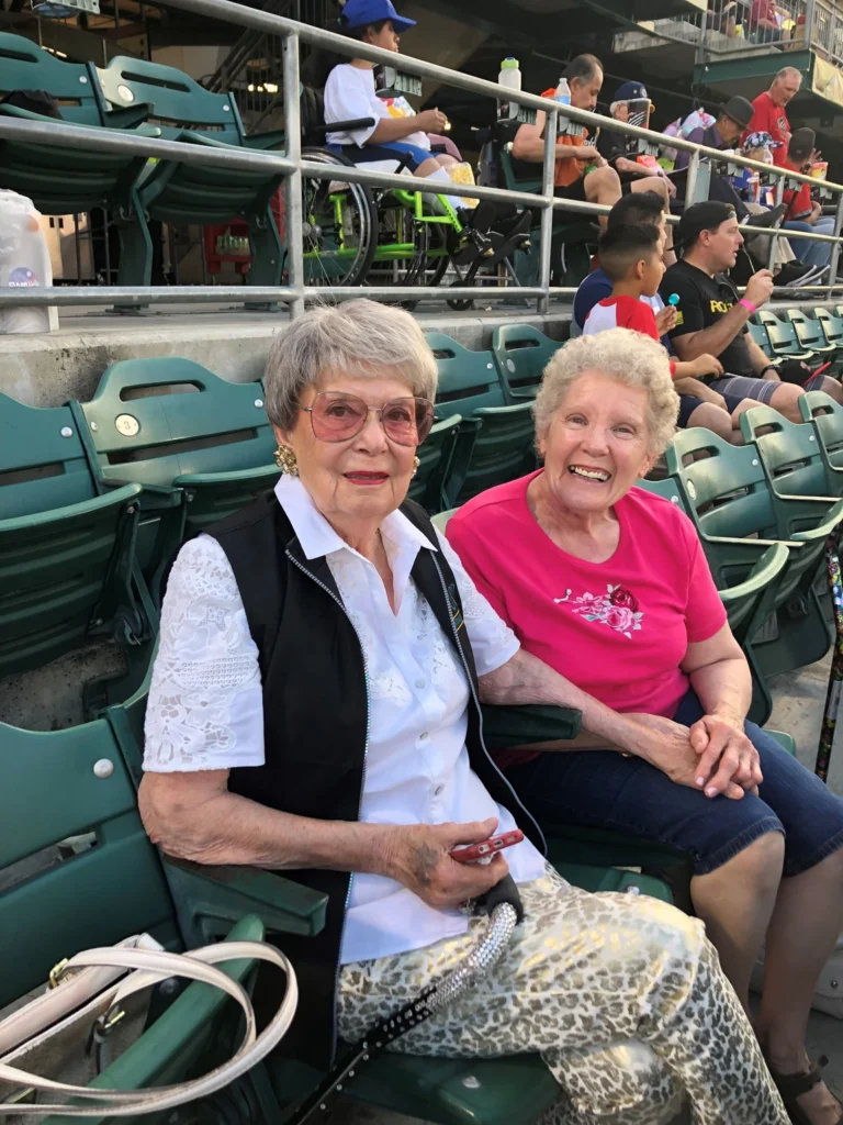 Vonny and friend Bonnie Peterson in a stadium.